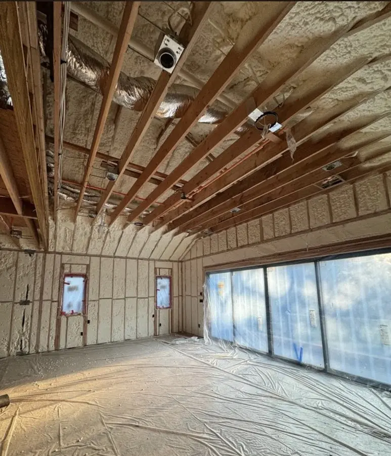 Interior walls and ceiling insulated with spray foam during new construction in Wright